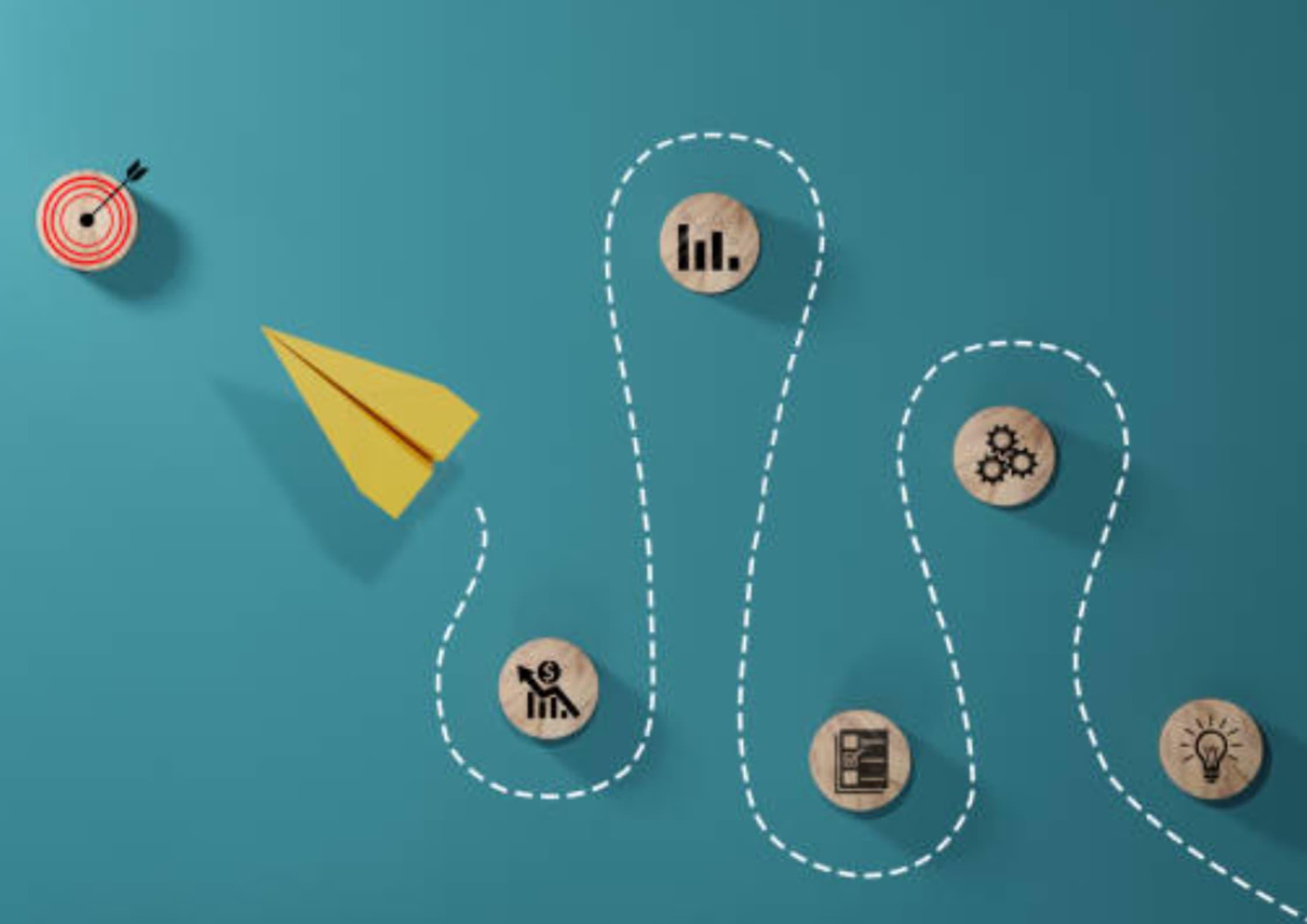 A yellow paper airplane on a teal background follows a dotted path passing wooden circles with business icons, aiming at a red target.